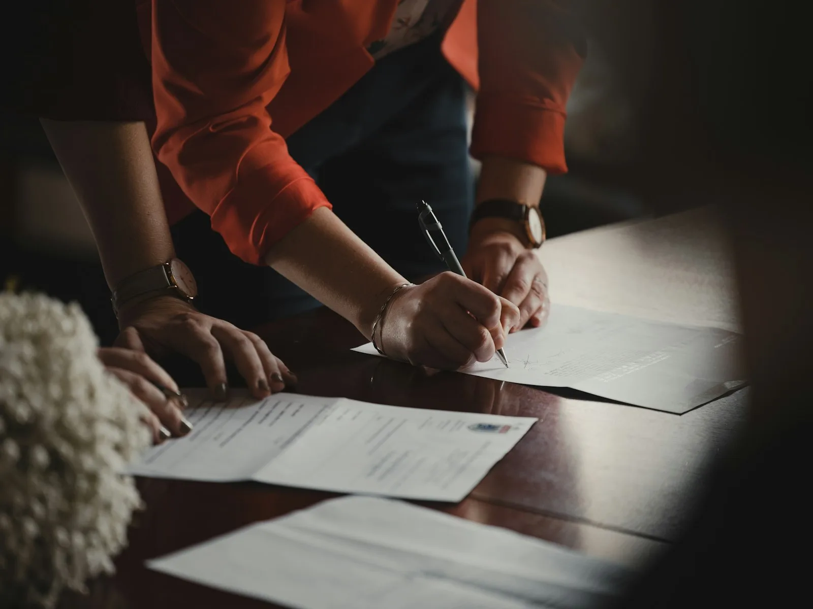 Signing a property title document, close-up of hands